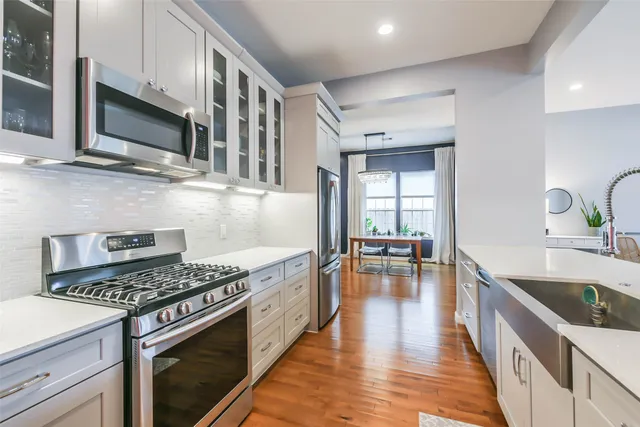 a kitchen with stainless steel appliances granite countertop a stove and a sink