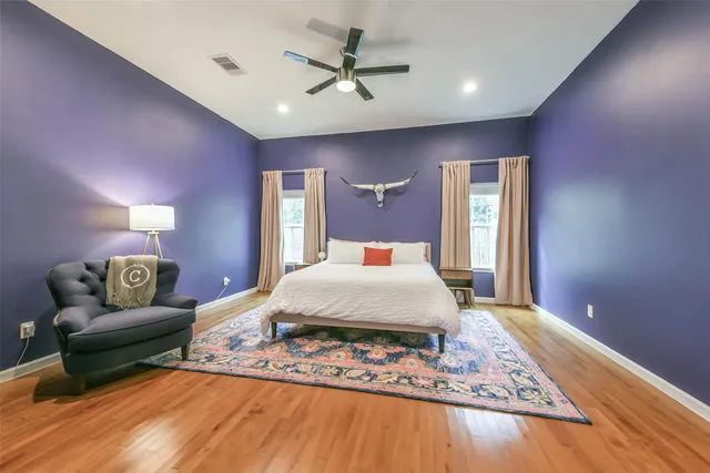 a bedroom with a bed mirror and window