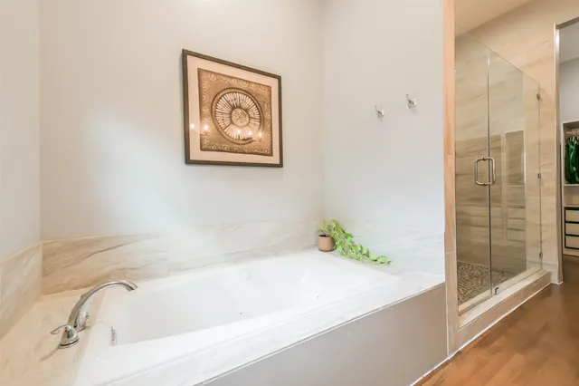 a bathroom with a tub and shower