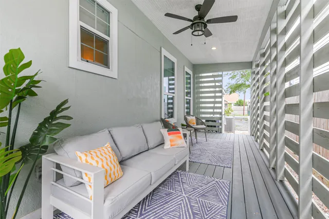 a living room with furniture and a potted plant