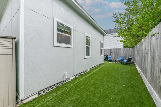 a backyard of a house with table and chairs