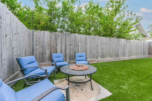 a backyard of a house with table and chairs