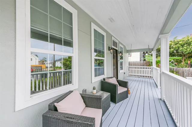 a balcony with furniture and wooden floor