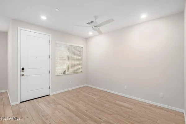a kitchen with a sink wooden floor and stainless steel appliances