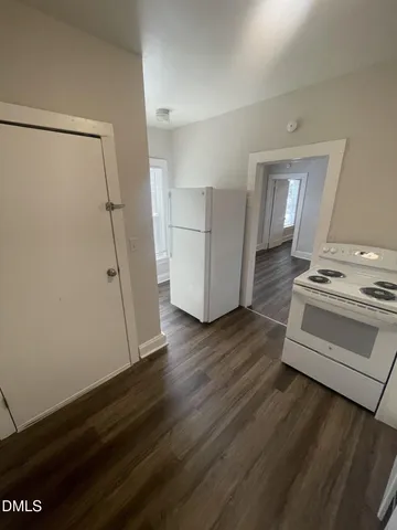 a view of kitchen with stove and refrigerator