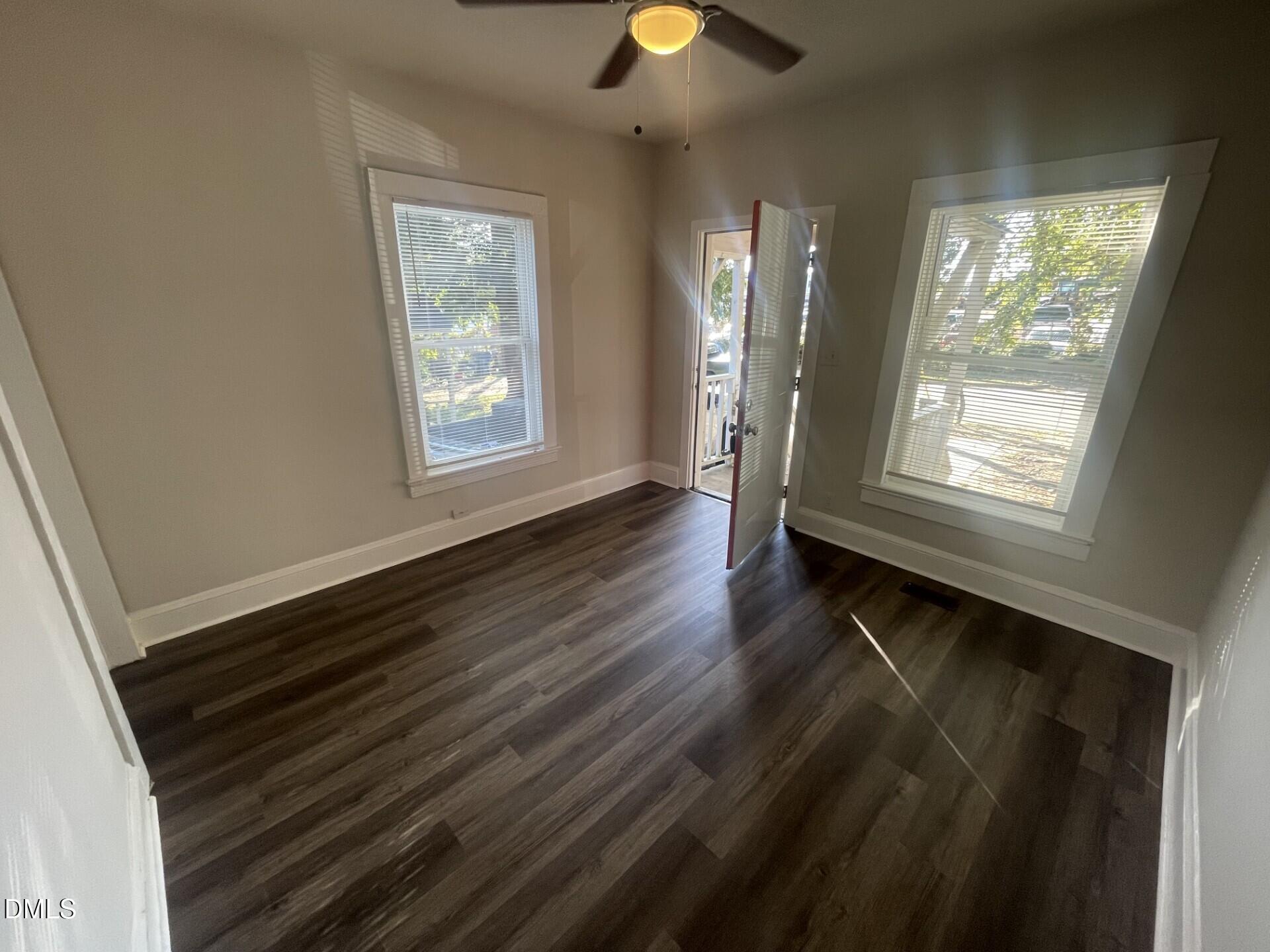307 Kennedy Street Raleigh, NC 27610 - Photo 3 of 12 a view of an empty room with wooden floor and a window