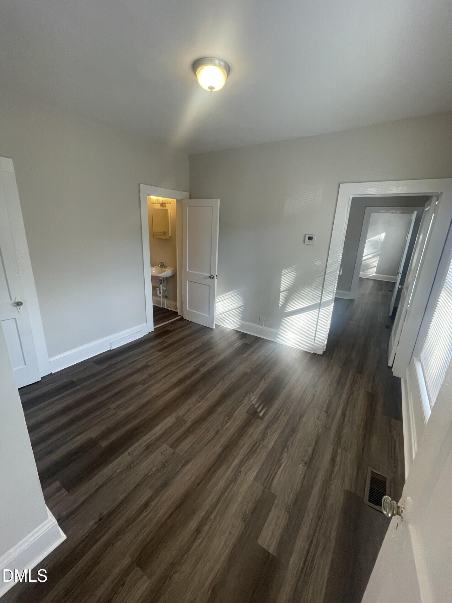 307 Kennedy Street Raleigh, NC 27610 - Photo 4 of 12 a view of an empty room and wooden floor