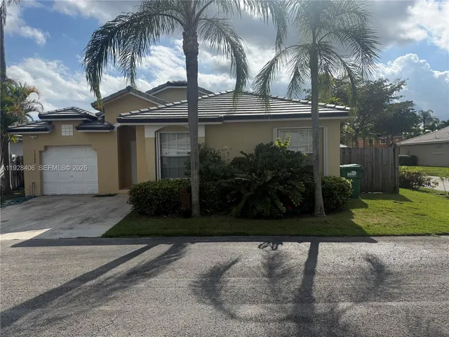 a view of a house with a yard and garage