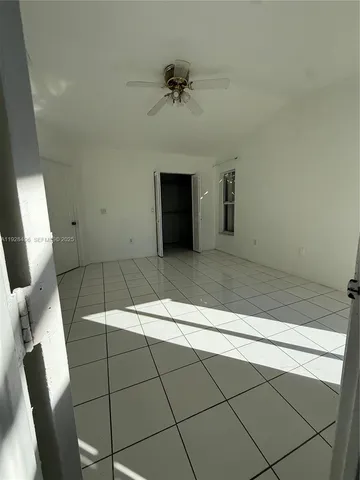 a view of a livingroom with furniture and chandelier fan