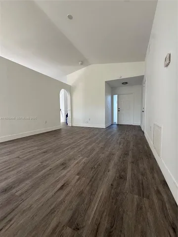 a view of a room with wooden floor