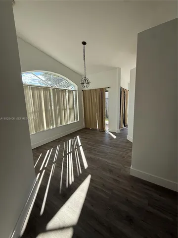 a view of an entryway with wooden floor