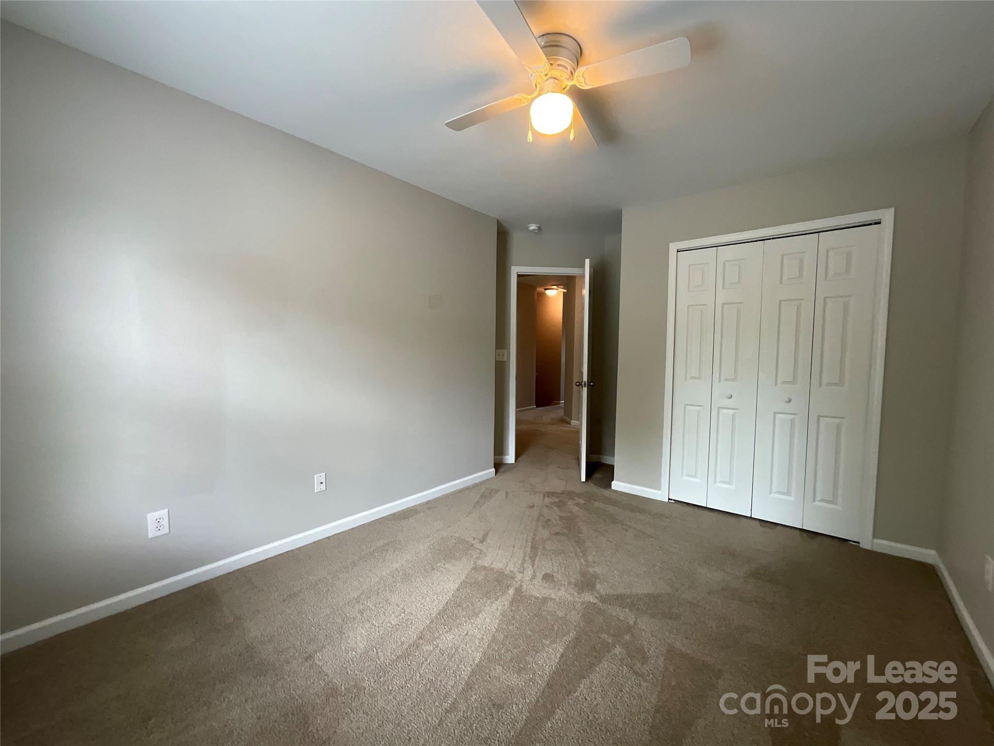 10846 Traders Court Davidson, NC 28036 - Photo 12 of 24 an empty room with closet and fan