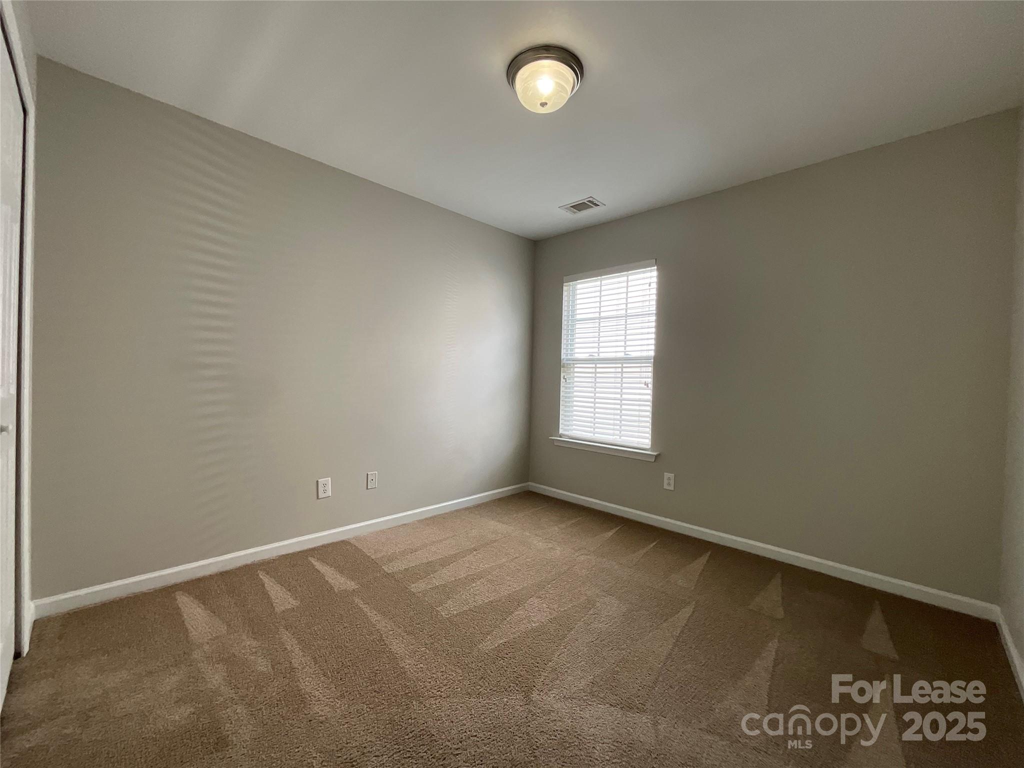 10846 Traders Court Davidson, NC 28036 - Photo 14 of 24 an empty room with a empty space and windows
