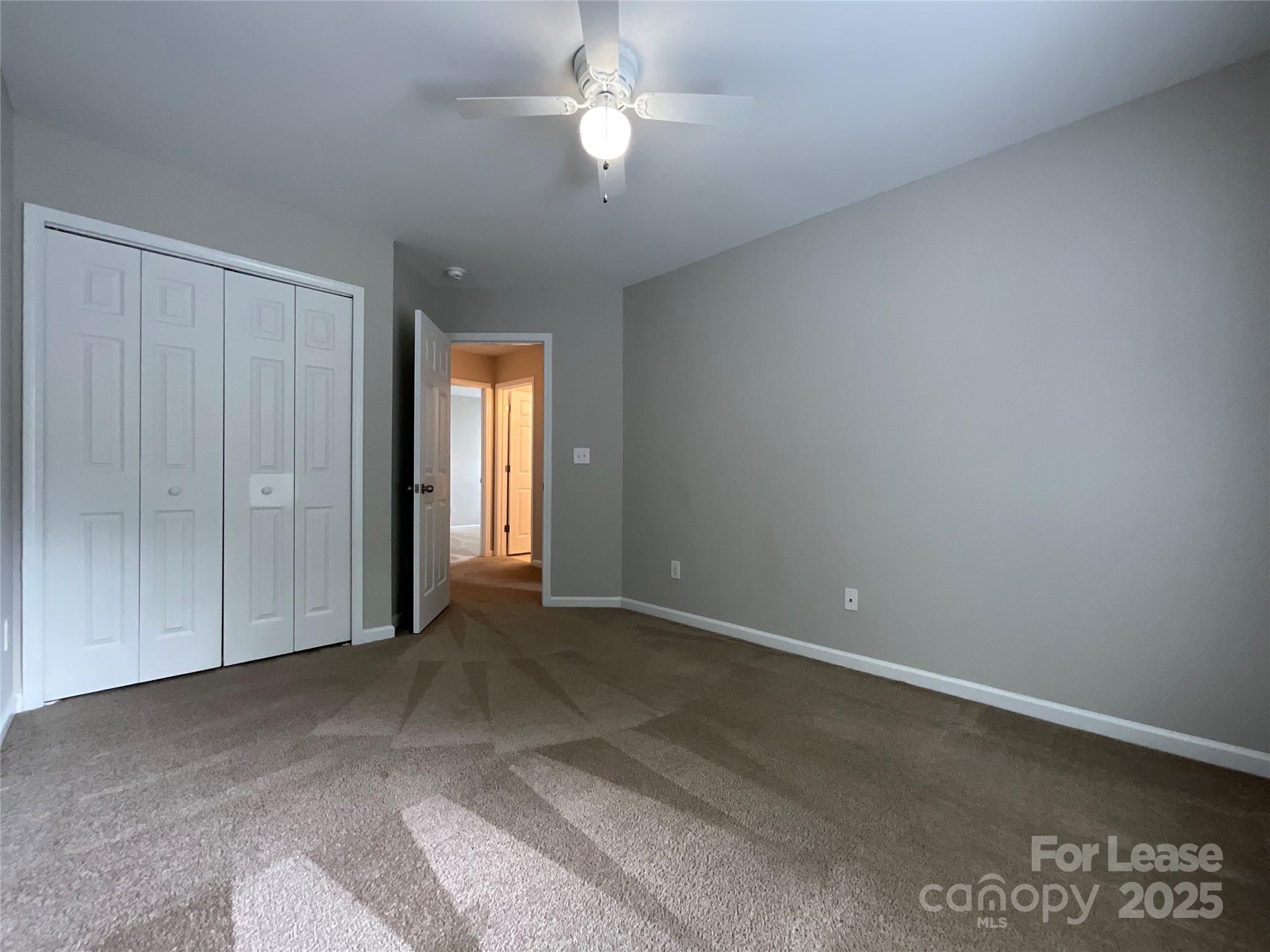 10846 Traders Court Davidson, NC 28036 - Photo 10 of 24 an empty room with windows and fan