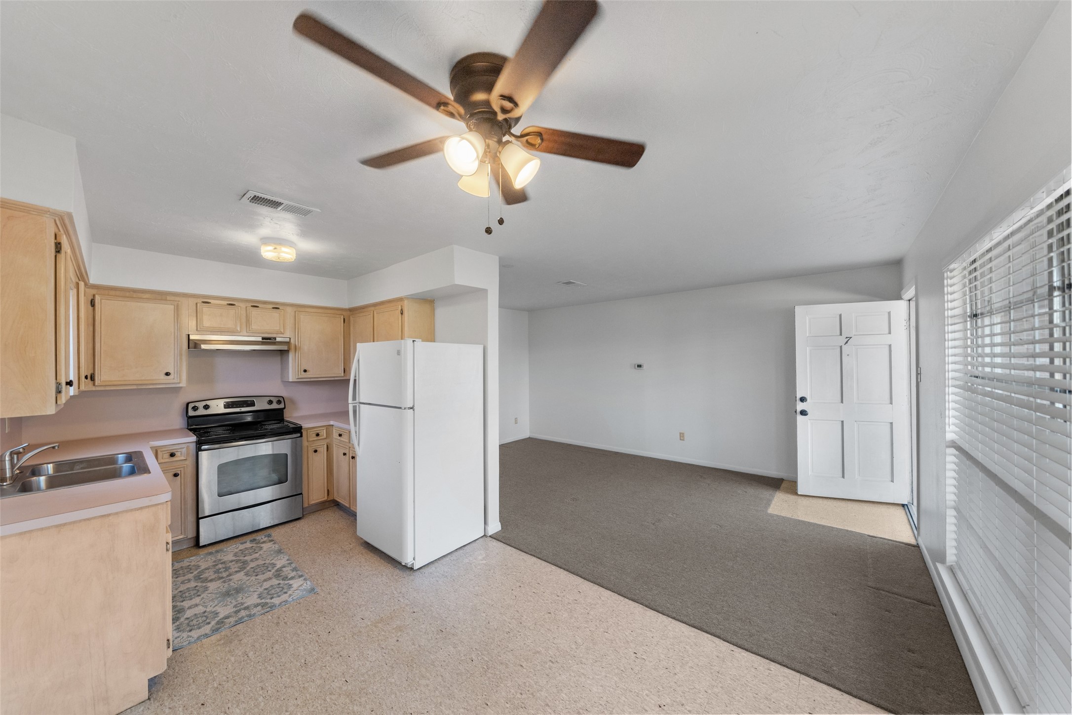 926 East 14th Street, Unit 7 Houston, TX 77009 - Photo 9 of 17 a kitchen with stainless steel appliances granite countertop cabinets and a refrigerator