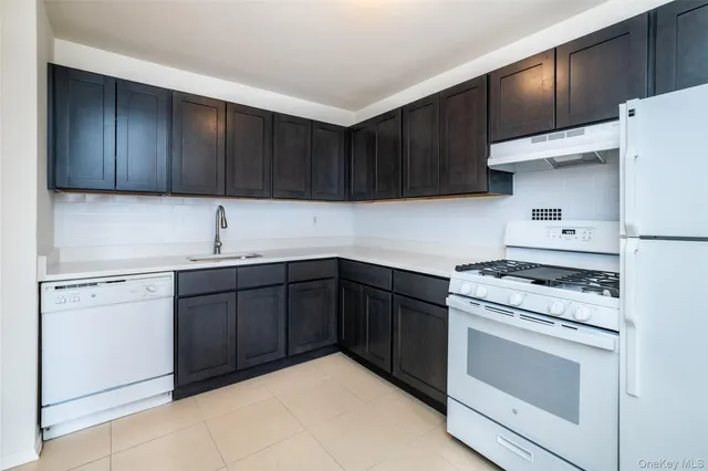 a kitchen with sink cabinets and stainless steel appliances
