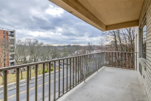 a balcony with trees in the back yard
