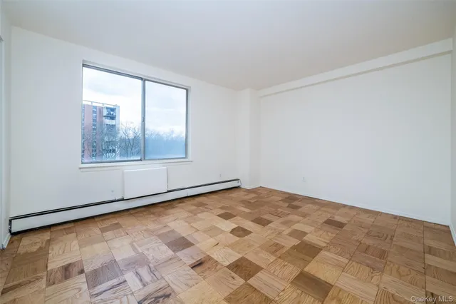a bedroom with a large bed and windows