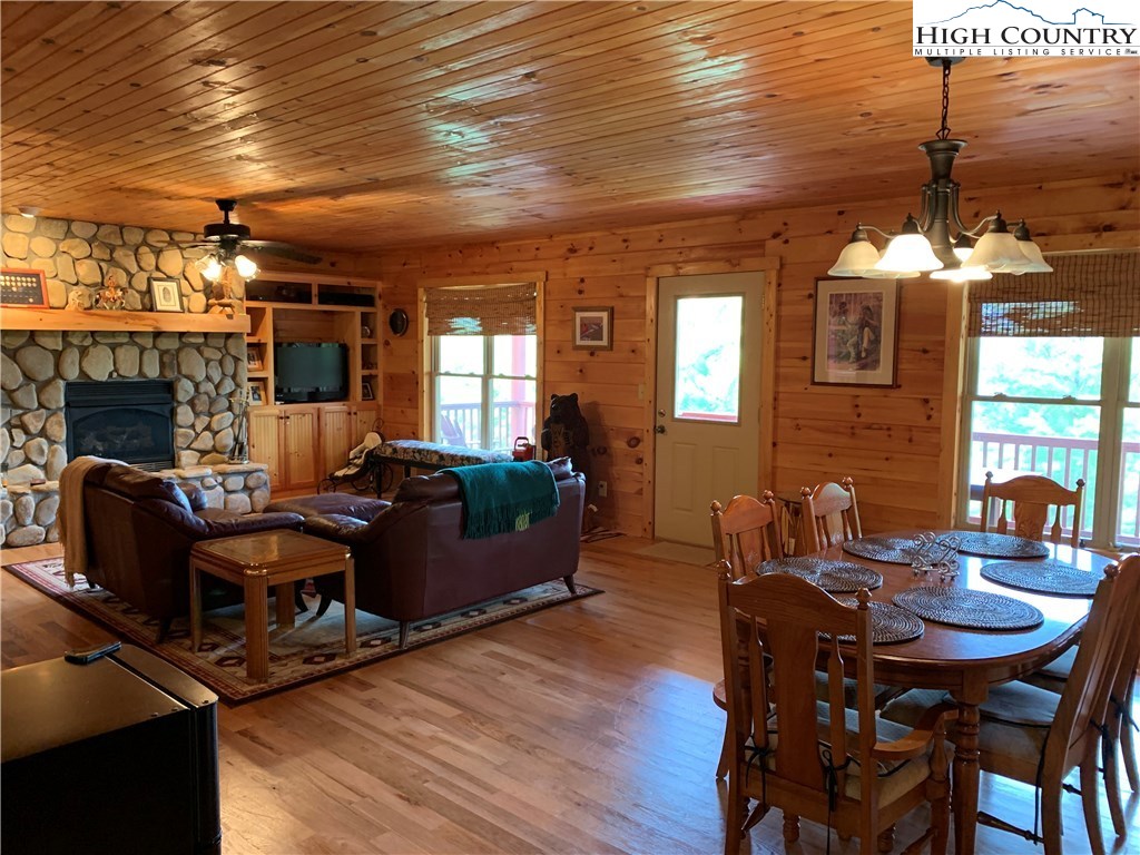 305 Wolf Pen Road Purlear, NC 28665 - Photo 23 of 40 a living room with furniture a fireplace and wooden floor
