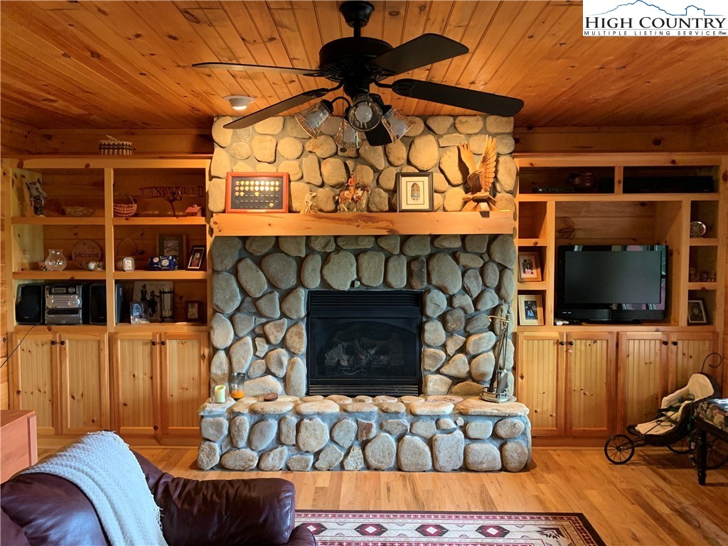 305 Wolf Pen Road Purlear, NC 28665 - Photo 27 of 40 a room with fireplace and flat screen tv
