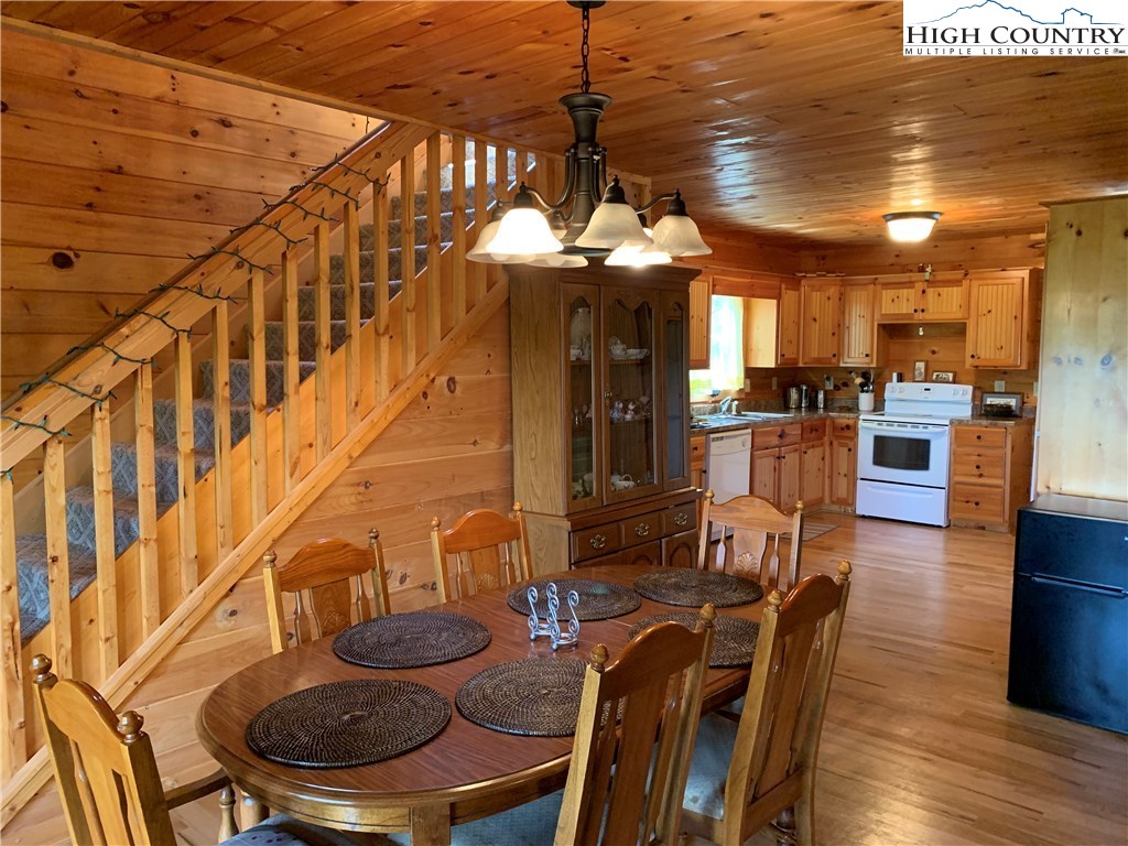 305 Wolf Pen Road Purlear, NC 28665 - Photo 28 of 40 a view of a dining room with furniture wooden floor and chandelier