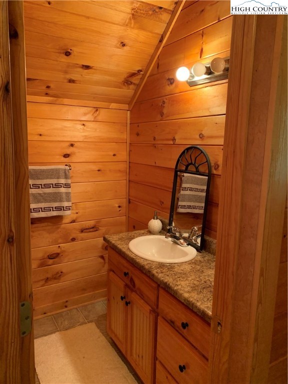 305 Wolf Pen Road Purlear, NC 28665 - Photo 36 of 40 a bathroom with a granite countertop sink and a mirror