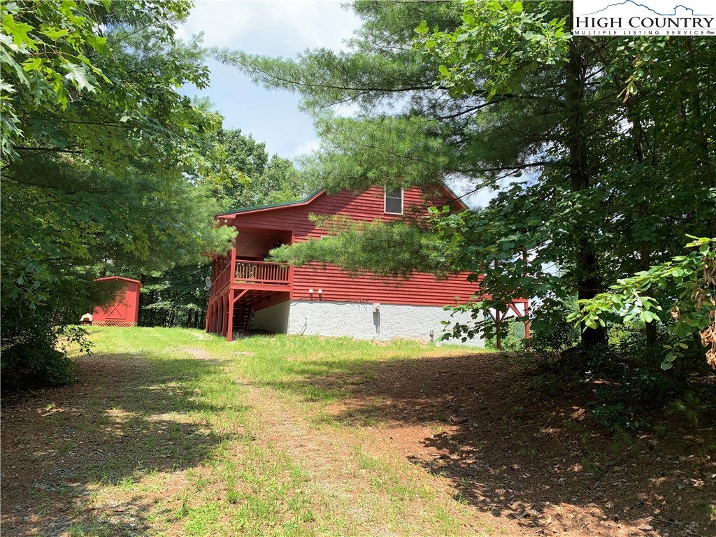 305 Wolf Pen Road Purlear, NC 28665 - Photo 4 of 40 a view of a house with a yard