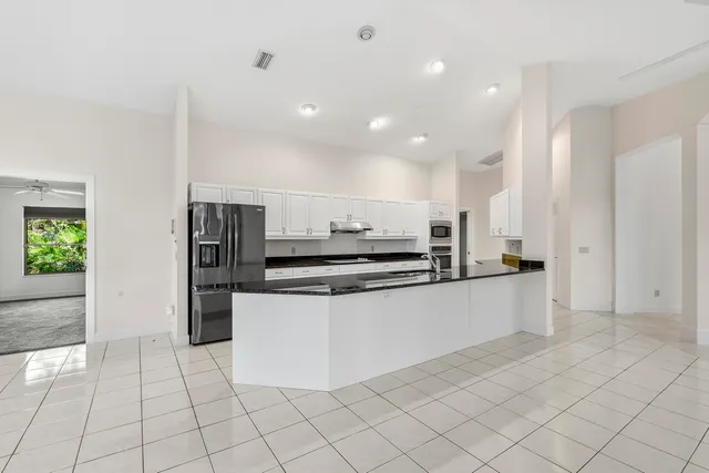 a view of an empty room with a fireplace and a window