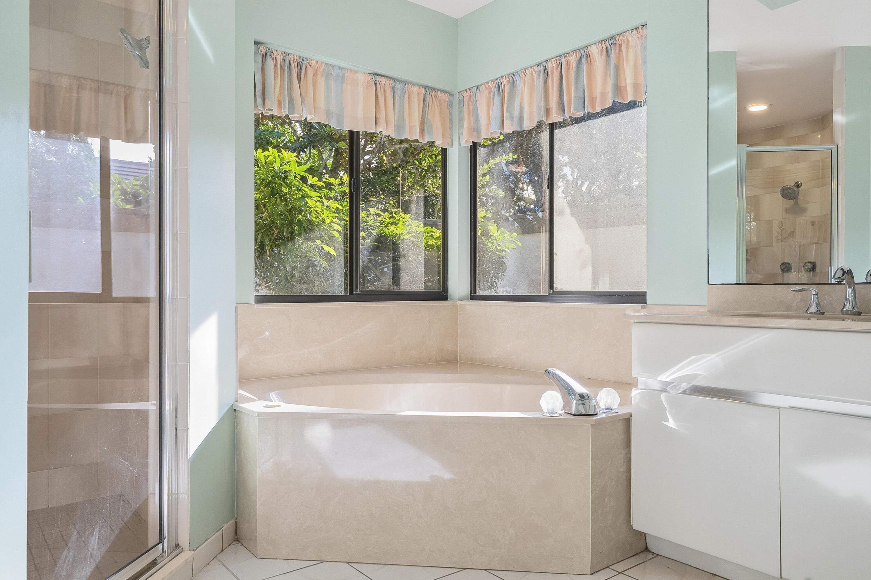 6469 Southeast Baltusrol Terrace Stuart, FL 34997 - Photo 29 of 65 a bath tub sitting in a bathroom next to a window