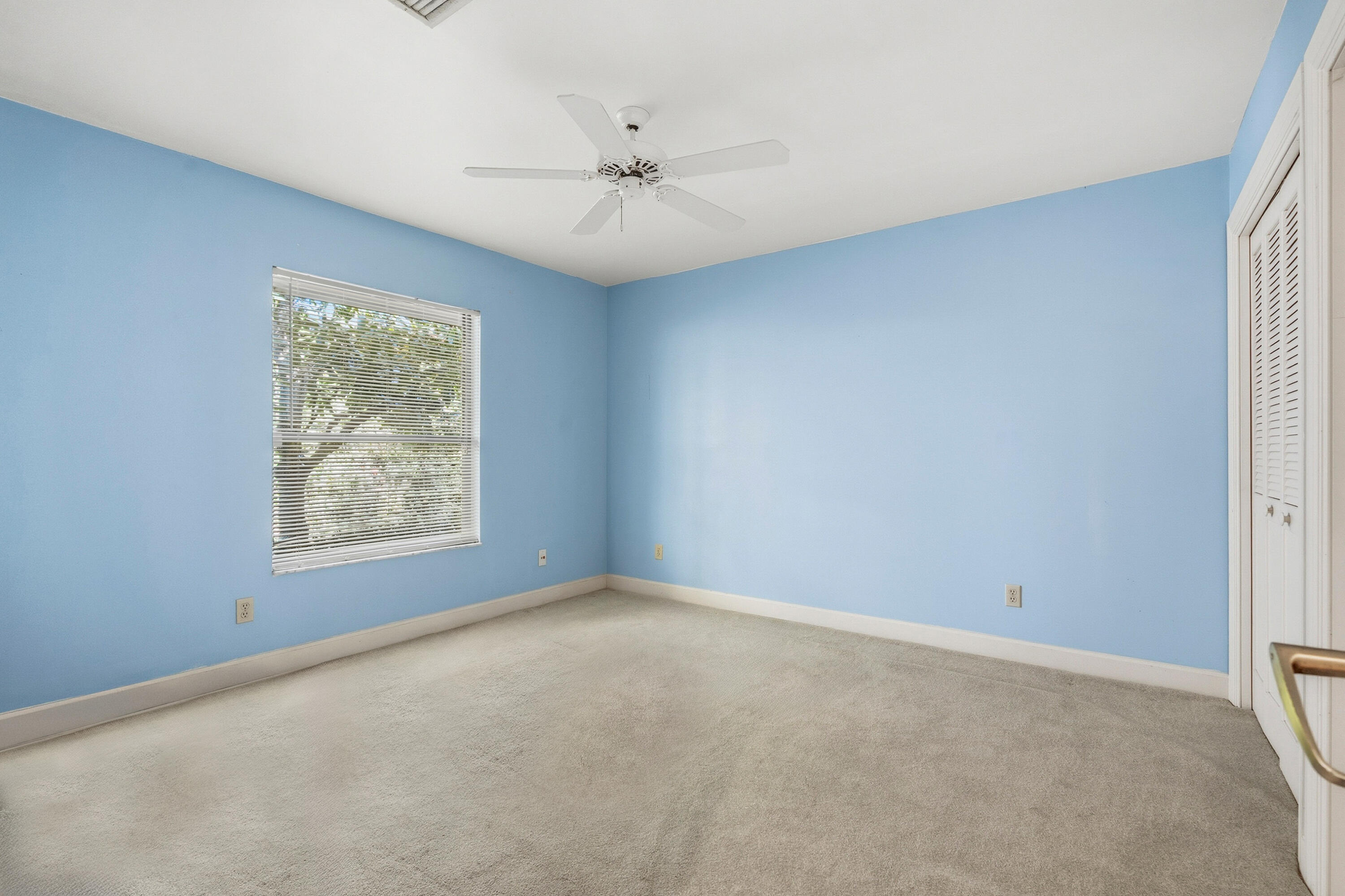 6469 Southeast Baltusrol Terrace Stuart, FL 34997 - Photo 32 of 65 an empty room with a window and a fan