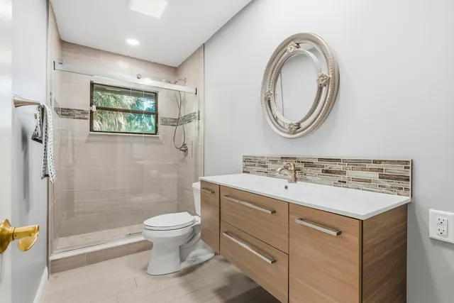 an aerial view of a house with swimming pool and garden