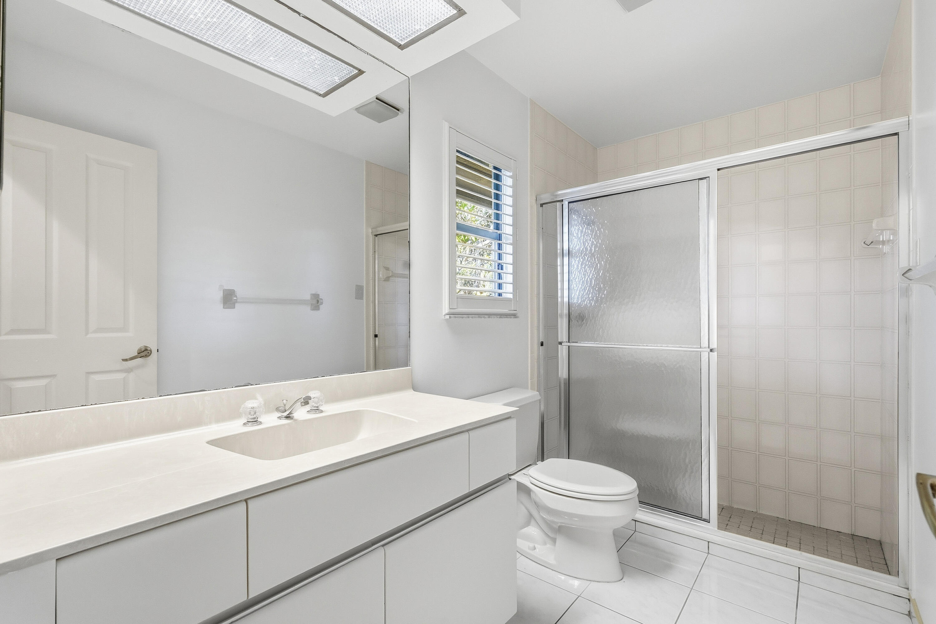 6469 Southeast Baltusrol Terrace Stuart, FL 34997 - Photo 35 of 65 a bathroom with a sink toilet and shower