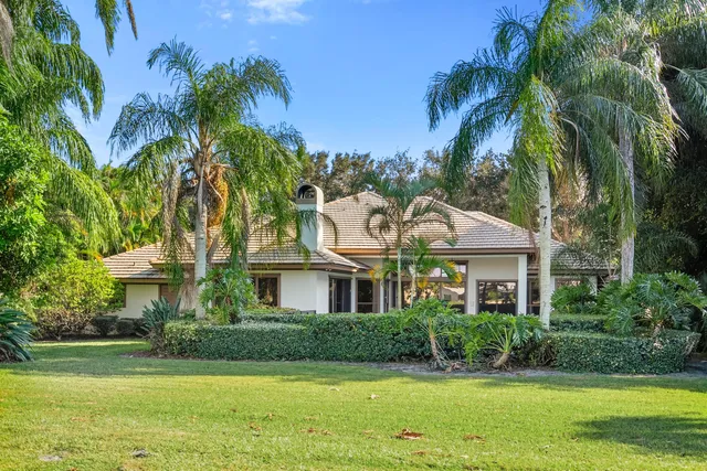 front view of a house with potted plants