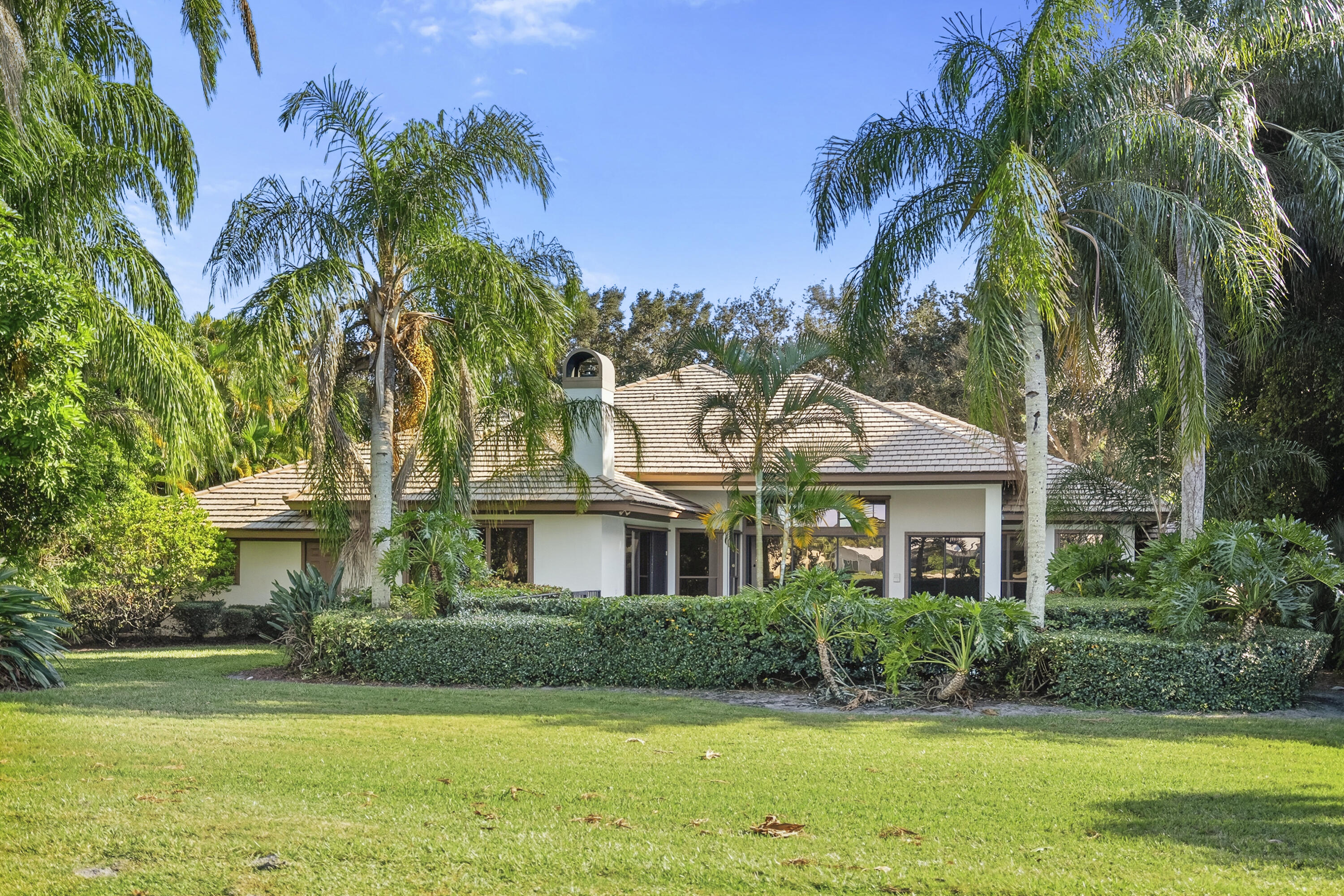 6469 Southeast Baltusrol Terrace Stuart, FL 34997 - Photo 41 of 65 a front view of a house with a yard