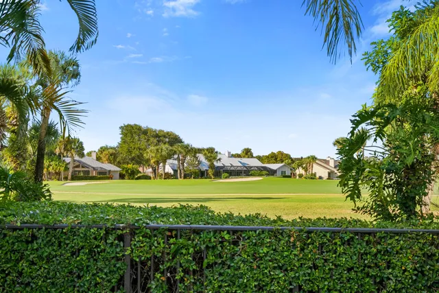 an open kitchen with stainless steel appliances kitchen island granite countertop a table chairs in it and wooden floors