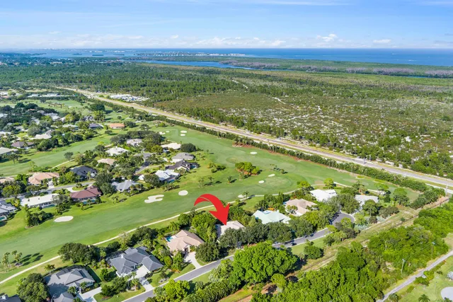 a view of a dining room with furniture a chandelier and wooden floor