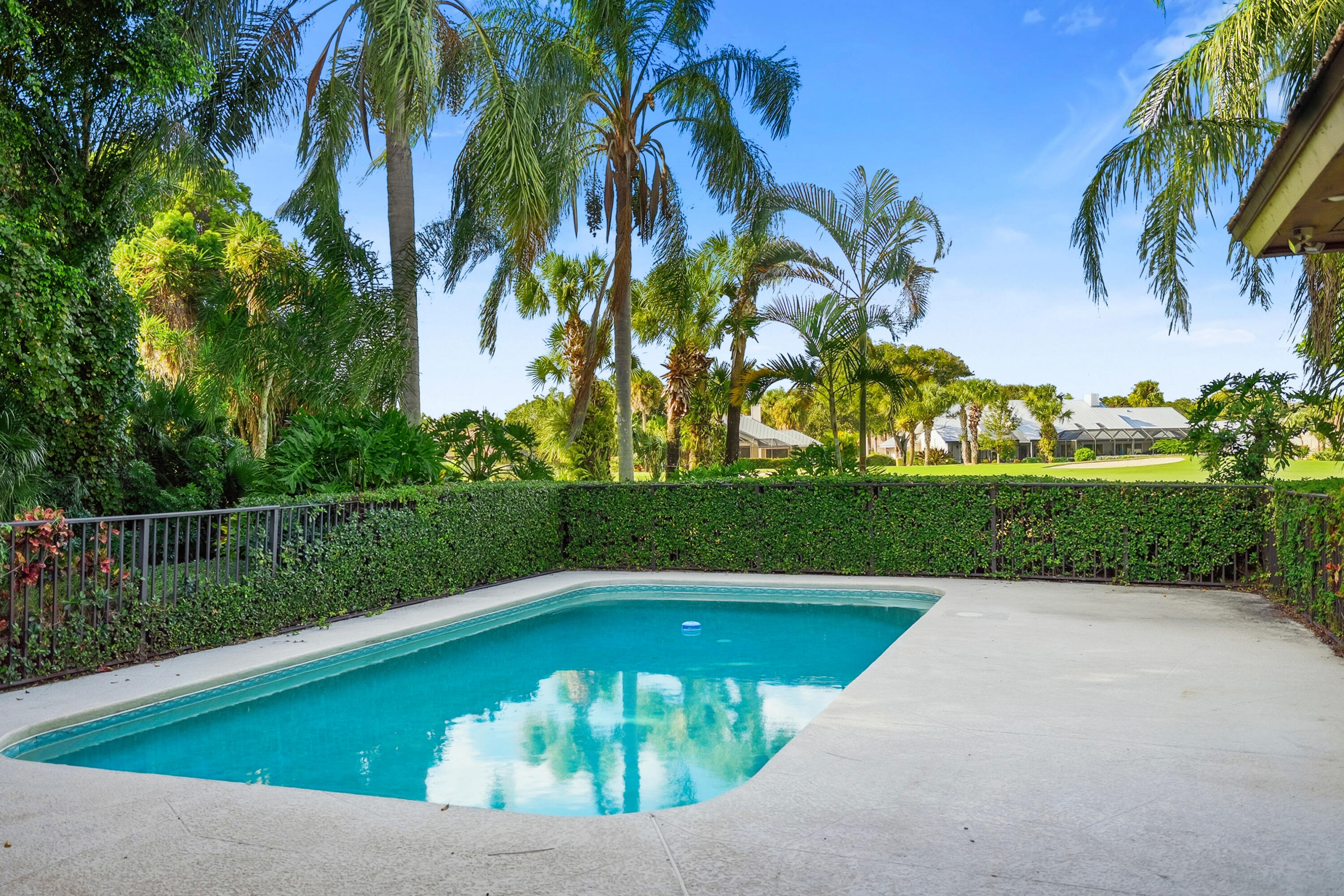 6469 Southeast Baltusrol Terrace Stuart, FL 34997 - Photo 7 of 65 a view of a swimming pool with a yard