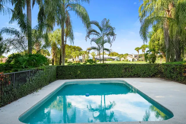 a view of a swimming pool with a table and chairs