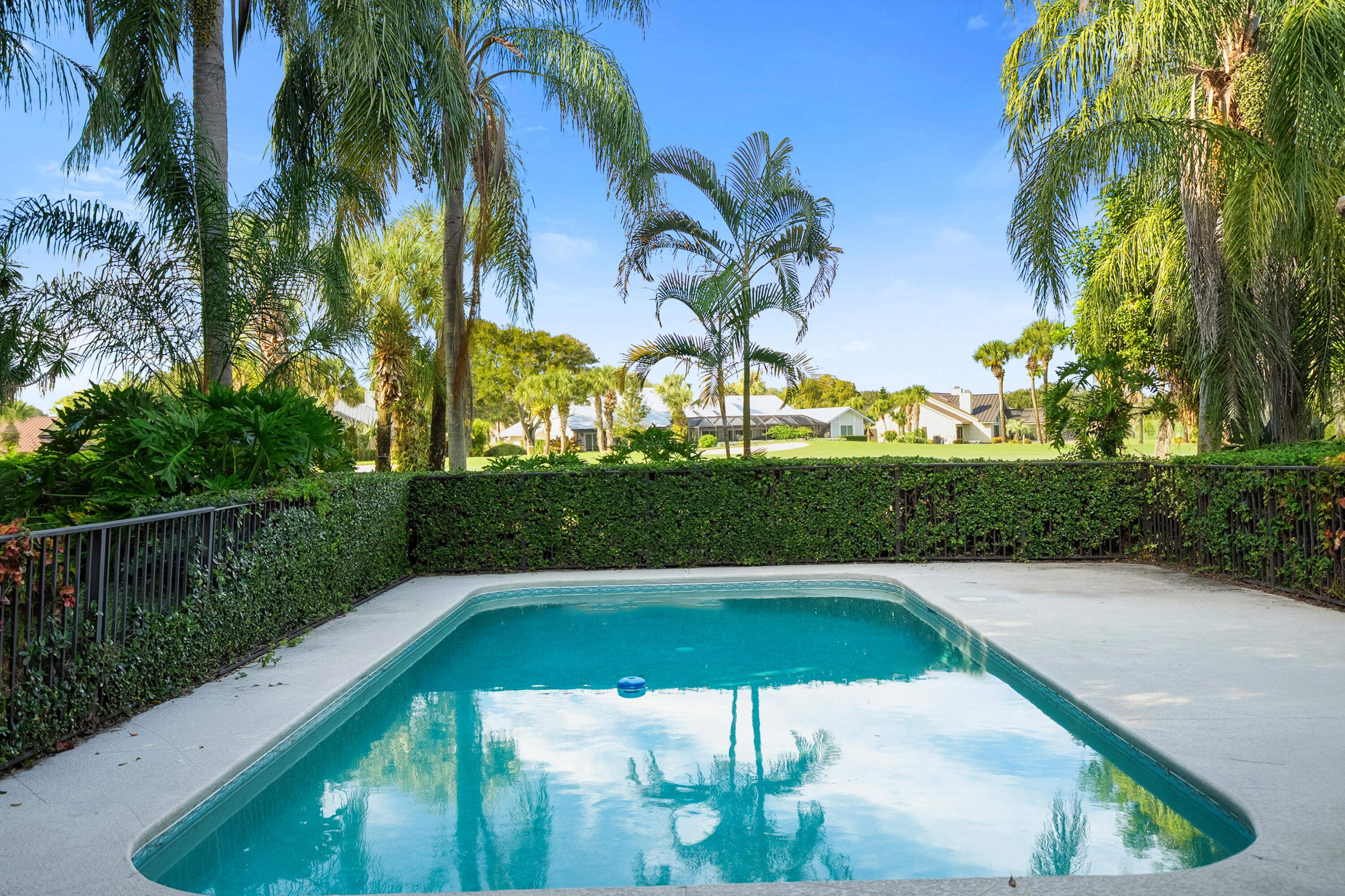 6469 Southeast Baltusrol Terrace Stuart, FL 34997 - Photo 8 of 65 a view of a swimming pool with a table and chairs