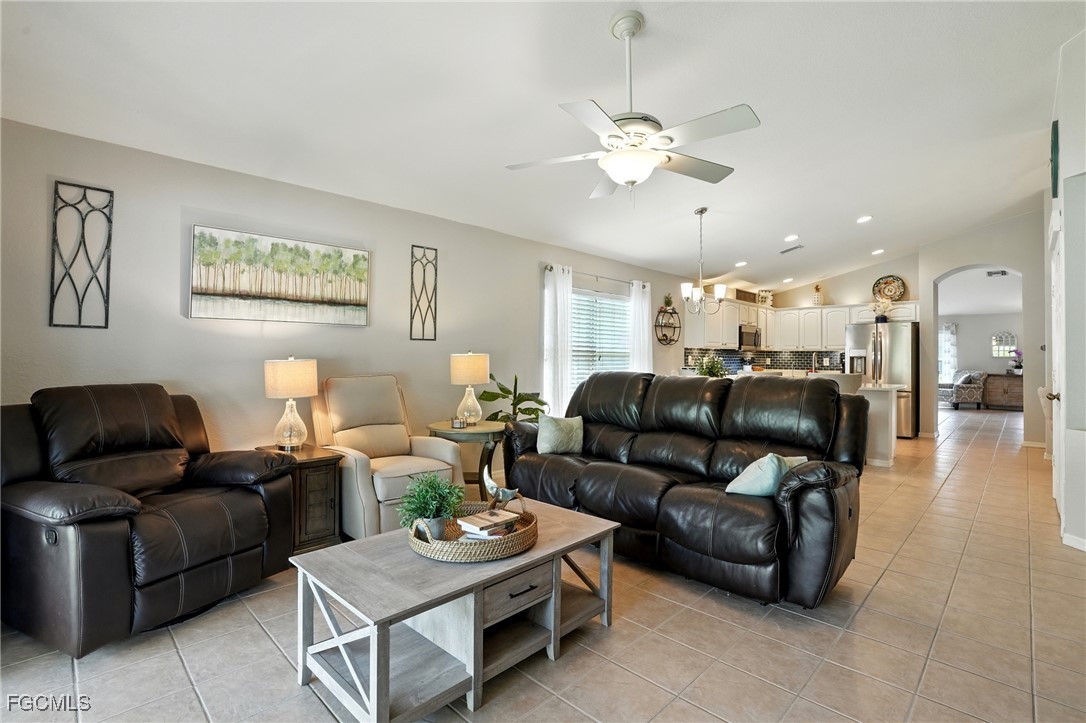 9740 Gladiolus Bulb Loop Fort Myers, FL 33908 - Photo 11 of 26 a living room with furniture and a chandelier
