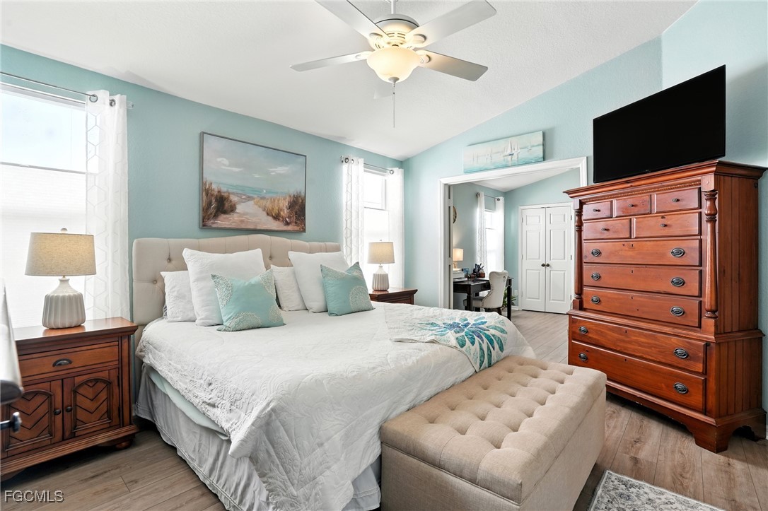 9740 Gladiolus Bulb Loop Fort Myers, FL 33908 - Photo 14 of 26 a bedroom with a bed and a flat screen tv