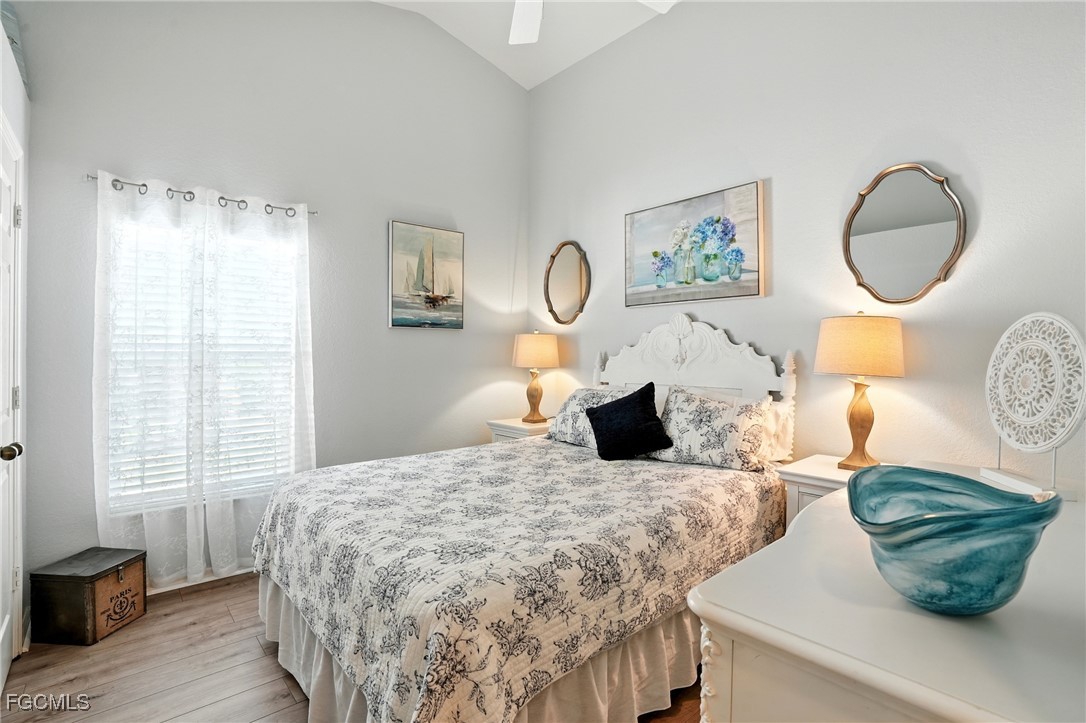 9740 Gladiolus Bulb Loop Fort Myers, FL 33908 - Photo 18 of 26 a bedroom with a bed mirror and window