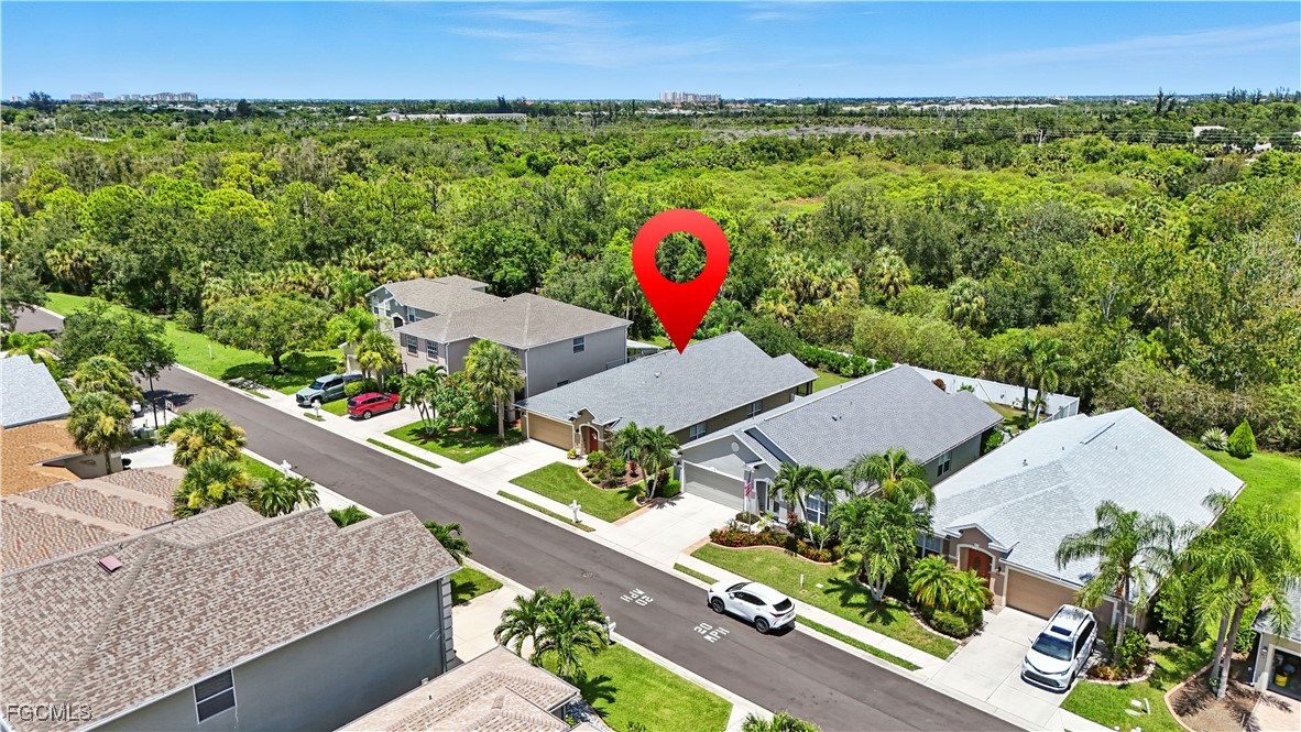9740 Gladiolus Bulb Loop Fort Myers, FL 33908 - Photo 2 of 26 an aerial view of a house with a yard and lake view