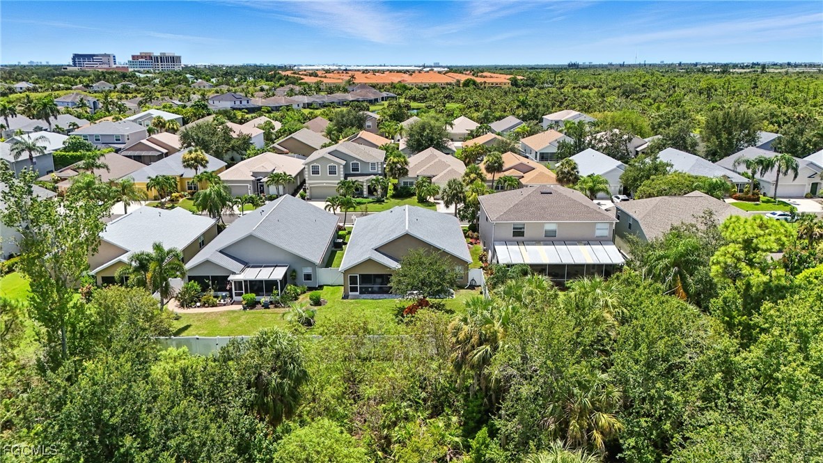 9740 Gladiolus Bulb Loop Fort Myers, FL 33908 - Photo 24 of 26 an aerial view of residential houses with outdoor space and trees