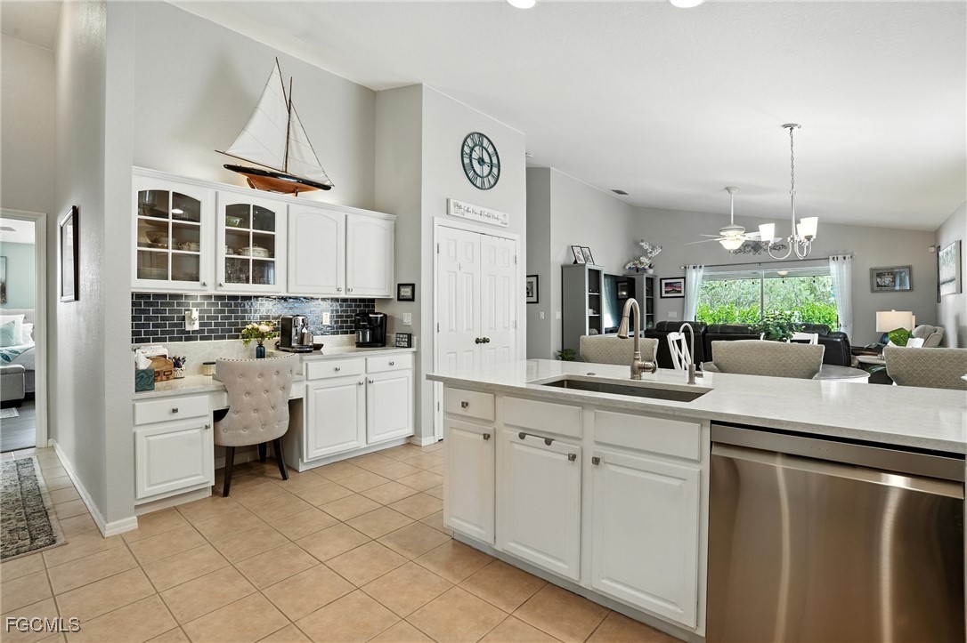 9740 Gladiolus Bulb Loop Fort Myers, FL 33908 - Photo 6 of 26 a kitchen with white cabinets and chandelier