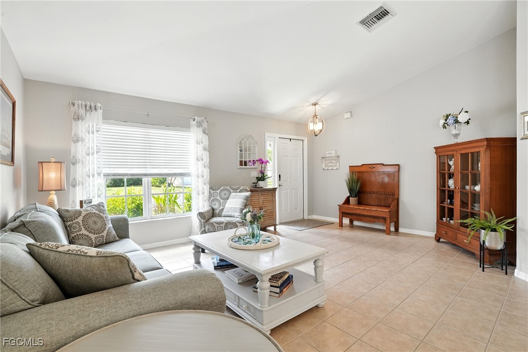 9740 Gladiolus Bulb Loop Fort Myers, FL 33908 - Photo 7 of 26 a living room with furniture and a flat screen tv