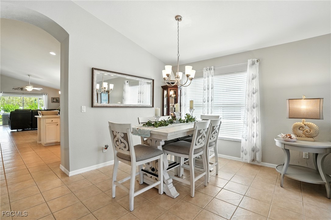 9740 Gladiolus Bulb Loop Fort Myers, FL 33908 - Photo 8 of 26 a view of a dining room with furniture and chandelier