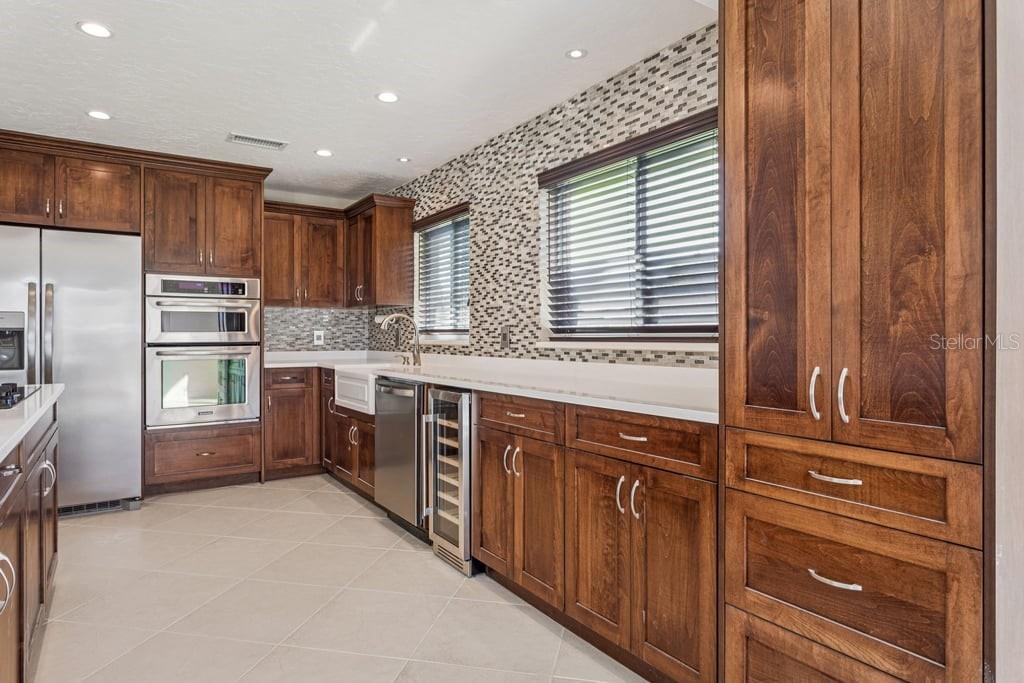 3734 Topsail Trail New Port Richey, FL 34652 - Photo 11 of 65 a kitchen with stainless steel appliances granite countertop a refrigerator and a stove top oven