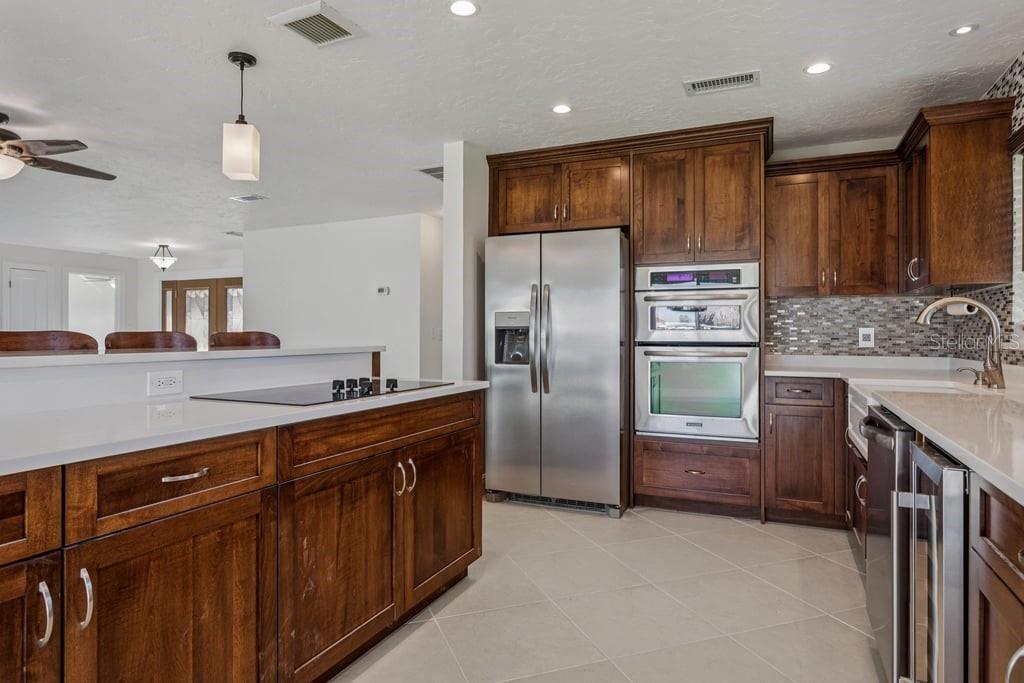 3734 Topsail Trail New Port Richey, FL 34652 - Photo 12 of 65 a kitchen with stainless steel appliances granite countertop a refrigerator a sink dishwasher and a stove