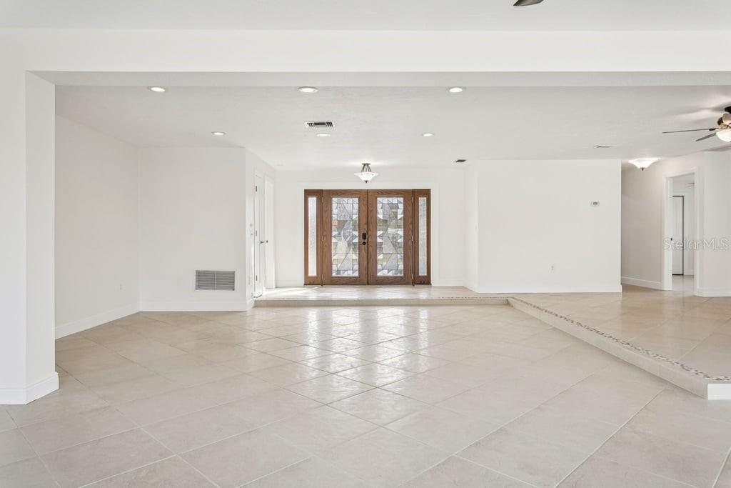 3734 Topsail Trail New Port Richey, FL 34652 - Photo 5 of 65 an empty room with wooden floor and natural light
